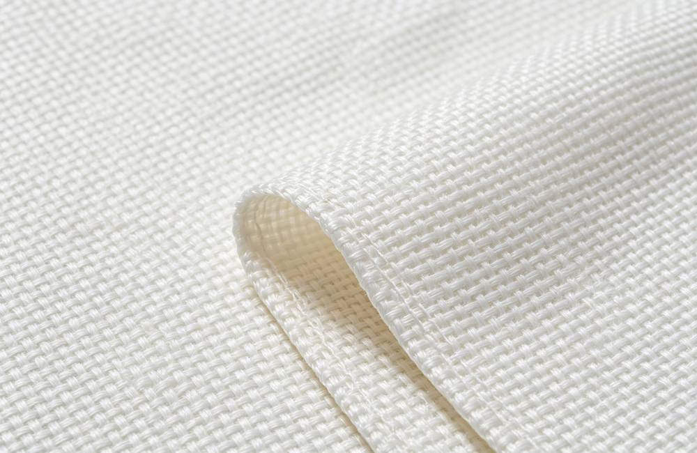 Close up woven glass fiber fire blanket texture showing tight weave and 550 degree heat resistance for bulk fire blanket orders today Close up woven glass fiber fire blanket texture showing tight weave and 550 degree heat resistance for bulk fire blanket orders today