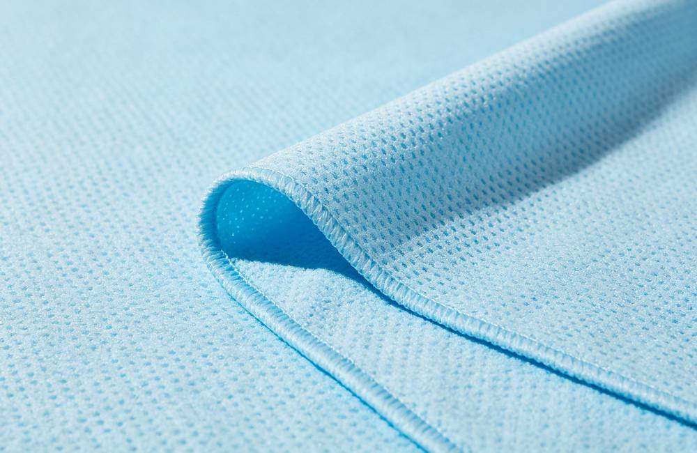 Close up PVA cooling towel porous fabric texture showing high absorbency surface for maximum evaporative cooling effect