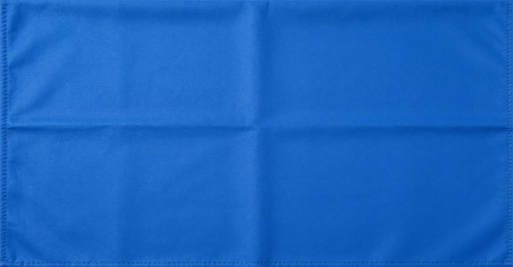 Close-up detail of blue fleece emergency blanket fabric showing soft woven texture and stitched edge demonstrating durable material