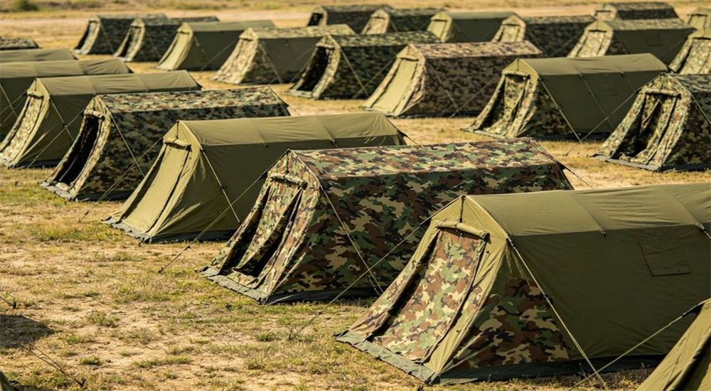 Military camouflage tent camp for field deployment and troop accommodation Military camouflage tent camp for field deployment and troop accommodation