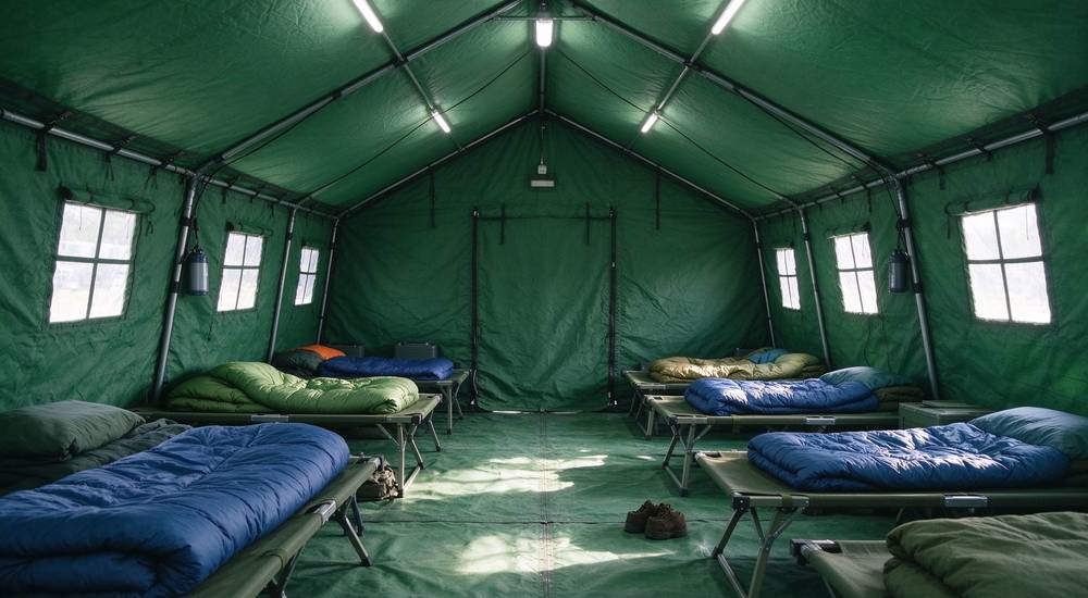 Portable generator running at emergency camp, realistic photography, reliable power supply for disaster response operations