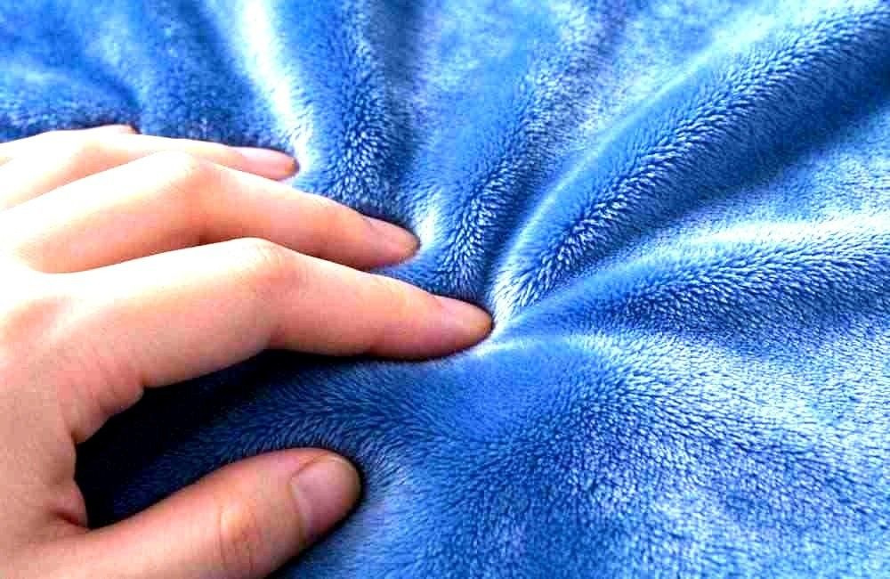 Close-up of woven blanket fabric texture in the production workshop for camp washing durability checks, showing durable blankets camp washing quality verification